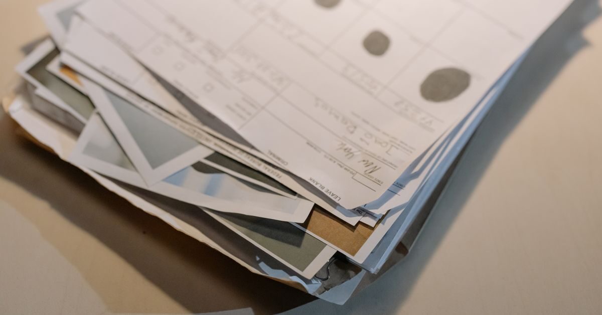 Research paper examples shown as a stack of printed papers on a desk